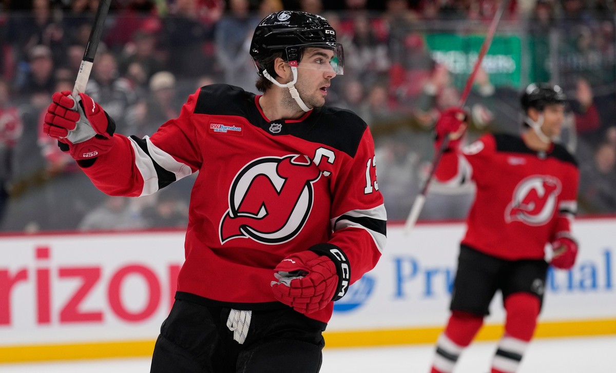 New Jersey Devils' Nico Hischier celebrates a goal by teammate Declan Chisholm during the second period of an NHL hockey game against the Colorado Avalanche in Newark, N.J., Tuesday, Oct. 20, 202 ...