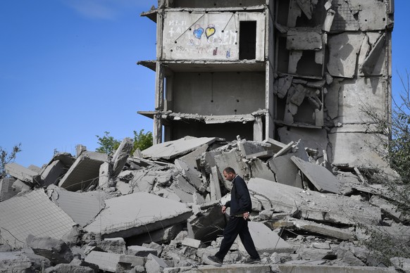 A local resident walks next to a house destroyed in a Russian shelling in Kramatorsk, Ukraine, Wednesday, May 25, 2022. (AP Photo/Andriy Andriyenko)