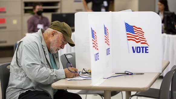 FILE - Voters cast their votes on September 23, 2022 in Minneapolis.  The upcoming midterm elections could give the stock market a much-needed boost by removing at least some of the uncertainty that…