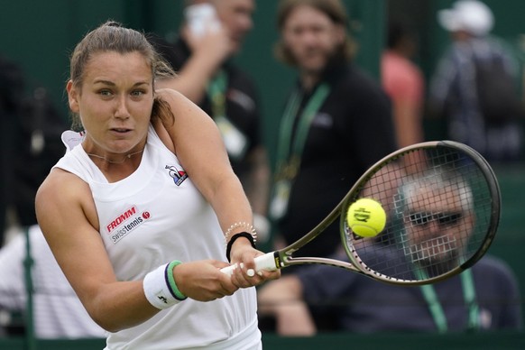 Switzerland's Ylena In-Albon returns the ball to Alison Riske of the US during their women's singles tennis match on day one of the Wimbledon tennis championships in London, Monday, June 27, 2022. (AP Photo/Alberto Pezzali)