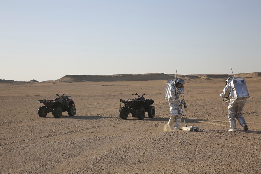 In this Feb. 7, 2018, photo, two scientists test space suits and a geo-radar for use in a future Mars mission in the Dhofar desert of southern Oman. The desolate desert in southern Oman resembles Mars ...