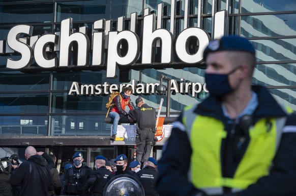 epa08891739 Supporters of Extinction Rebellion protest at Schiphol Airport, Schiphol, The Netherlands, 18 December 2020. Despite the severe coronavirus pandemic caused lockdown, the airport remains op ...