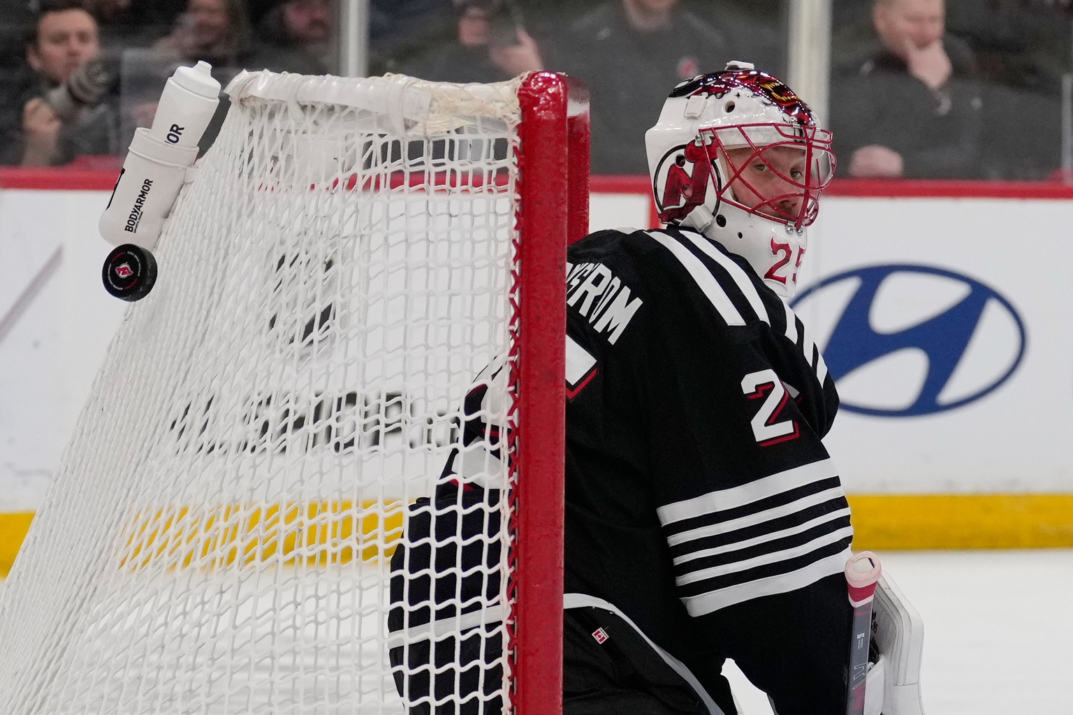 New Jersey Devils goaltender Jacob Markstrom defends the net during the first period of an NHL hockey game against the Calgary Flames in Newark, N.J., Thursday, March 12, 2026. (AP Photo/Seth Wenig)
J ...