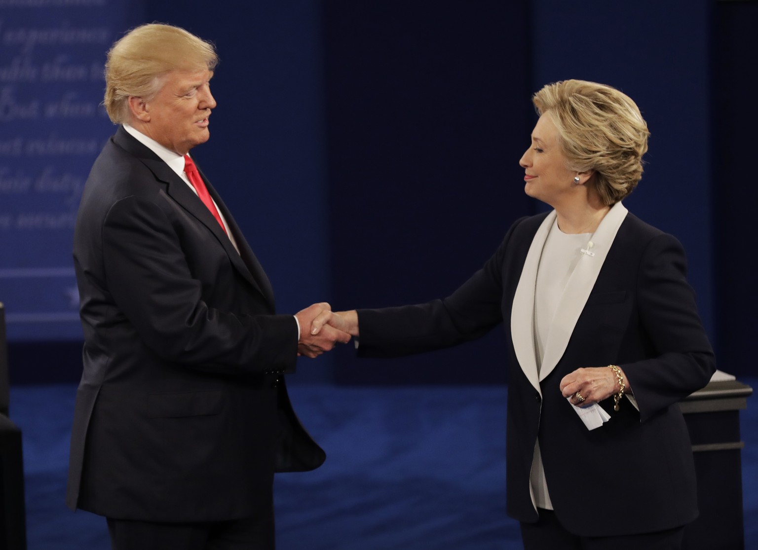 Republican presidential nominee Donald Trump shakes hands with Democratic presidential nominee Hillary Clinton following the second presidential debate at Washington University in St. Louis, Sunday, O ...
