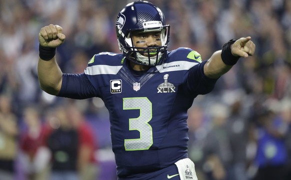 FILE - In this Feb. 1, 2015, file photo, Seattle Seahawks quarterback Russell Wilson celebrates after throwing a touchdown pass during the first half of NFL Super Bowl XLIX football game against the N ...
