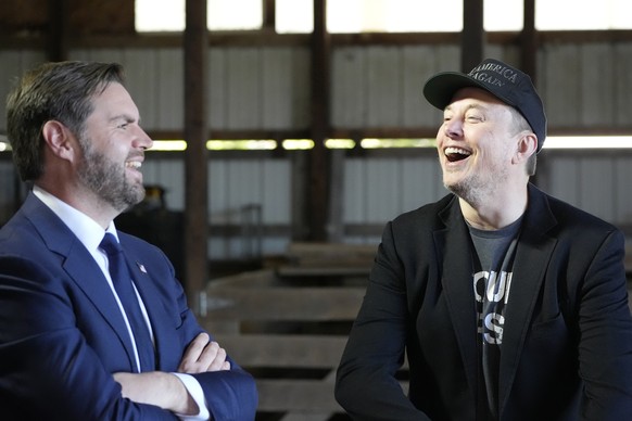 Tesla and SpaceX CEO Elon Musk, right, and Republican vice presidential nominee Sen. JD Vance, R-Ohio, attend a campaign event with Republican presidential nominee former President Donald Trump at the ...