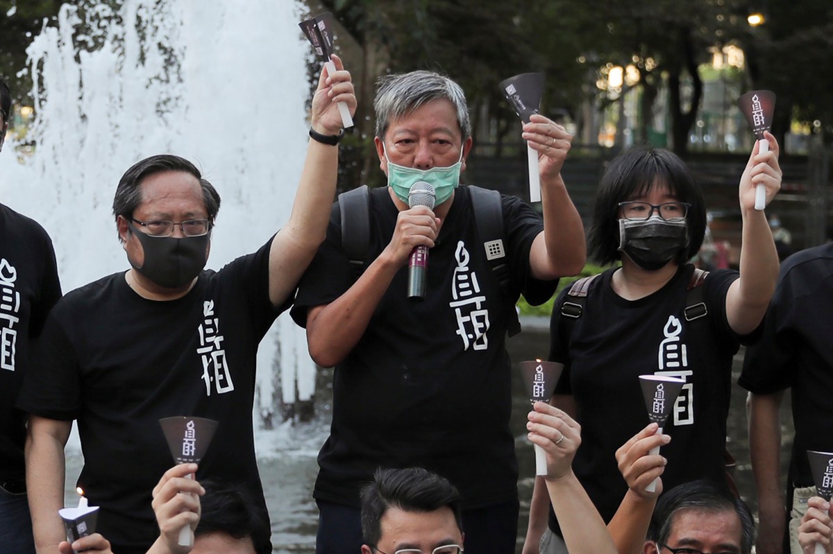 FILE - Pro-democracy activists including from left Albert Ho, Lee Cheuk-yan and Chow Hang-tung shout slogans during a gathering to mourn those killed in the 1989 Tiananmen crackdown at Victoria Park i ...