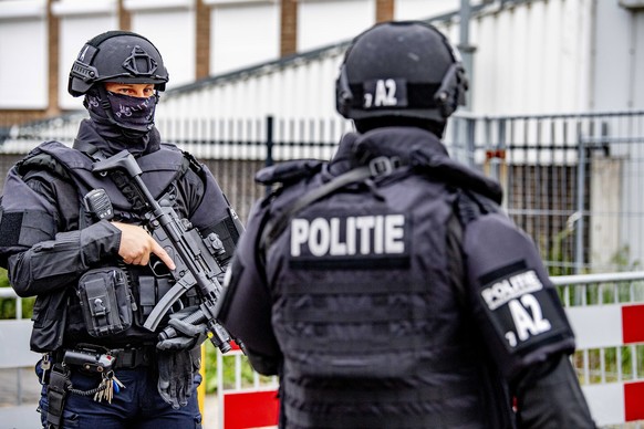 epa09310736 Officers of the special police unit at the bunker, the extra secured court, prior to the pro forma hearing of the multi-day Marengo trial, in Amsterdam, Netherlands, 29 June 2021. Seventee ...