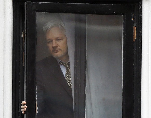 FILE - In this Feb. 5, 2016 file photo, Wikileaks founder Julian Assange walks onto the balcony of the Ecuadorean Embassy in London. An Ecuadorean judge ruled Monday, Oct. 29, 2018 against a request b ...