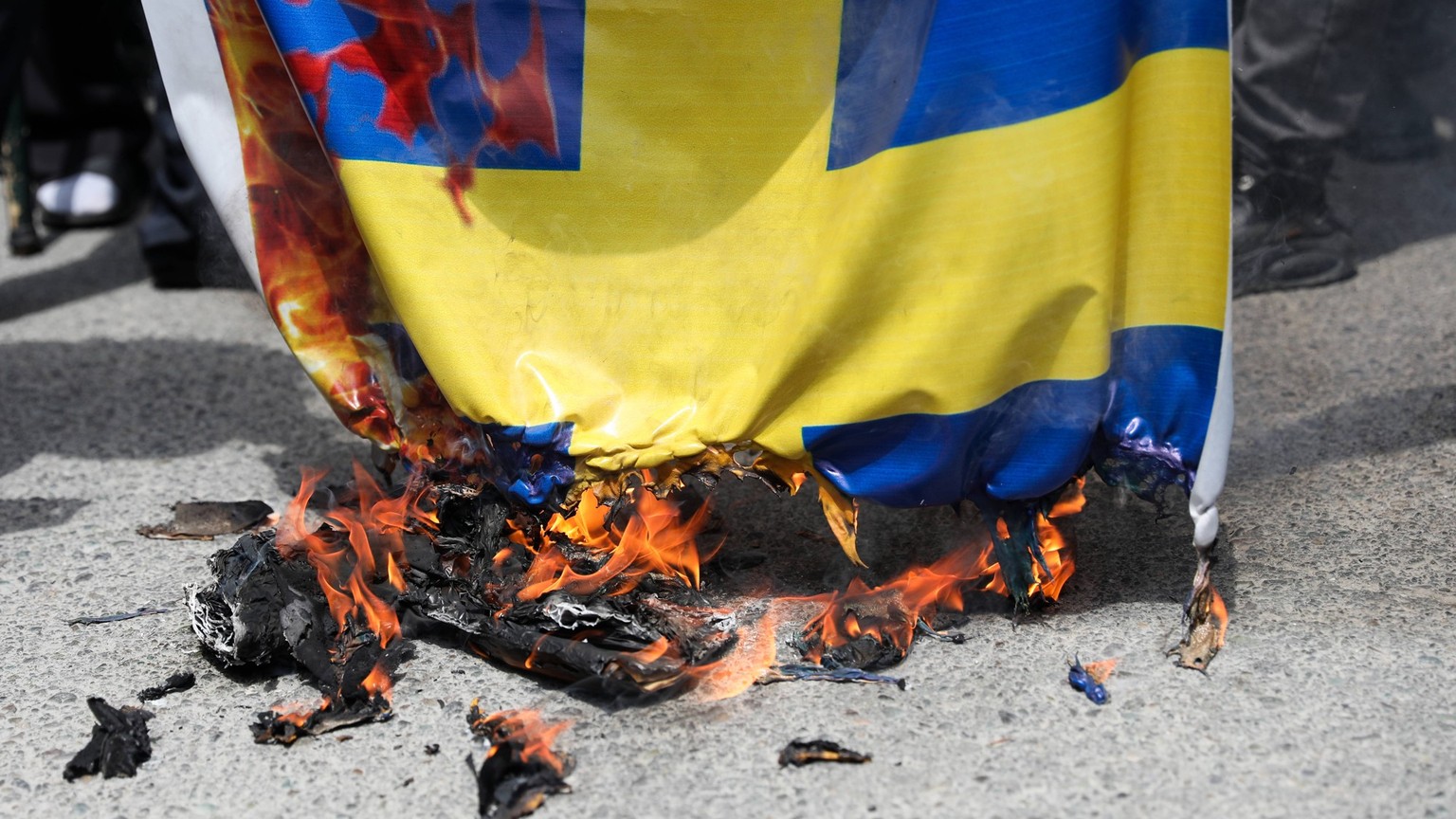 Iran: Demonstrations against the burning of the Quran Iranian demonstrators burn a Swedish flag, during a protest of the burning of a Quran in Sweden, in Tehran, Iran, Friday, July 21, 2023. On Thursd ...