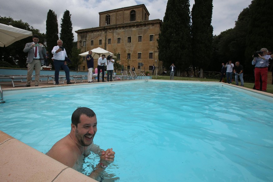epa06860612 Interior Minister Matteo Salvini bathes in the swimming pool during the visit at a farm which was confiscated in 2007 to the Italian mafia, in Suvignano (Siena), central Italy, 03 July 201 ...
