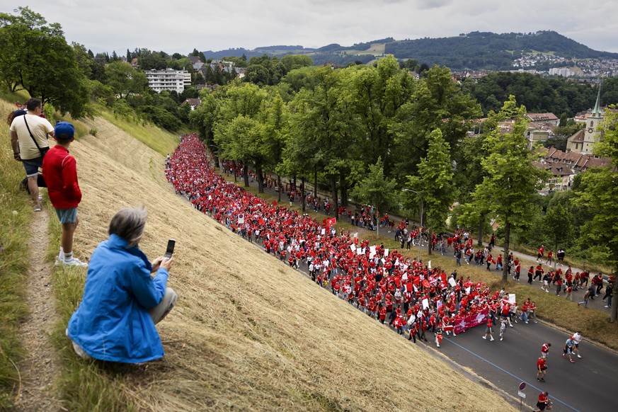 Swiss fans walk towards the stadium during a fanwalk prior to the UEFA Women&#039;s EURO 2025 Group A soccer match between Switzerland and Iceland at the Wankdorf stadium in Bern, Switzerland, on Sund ...