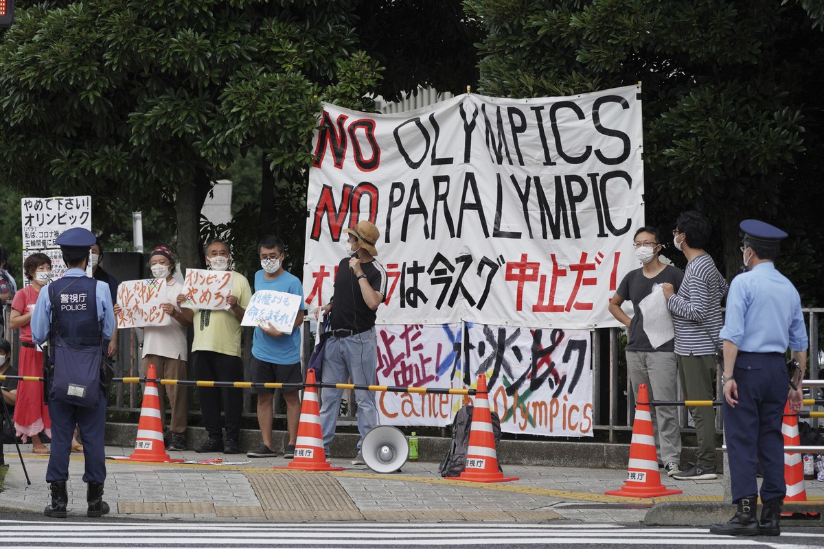 Protesters demonstrate in front of the Prime Minister's Office in Tokyo, Japan, Monday, Aug. 2, 2021. They were protesting against the Olympics and Paralympics held during the pandemic as Japan h ...