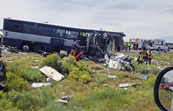 This photo provided by Chris Jones shows first responders working the scene of a collision between a Greyhound passenger bus and a semi-truck on Interstate 40 near the town of Thoreau, N.M., near the  ...