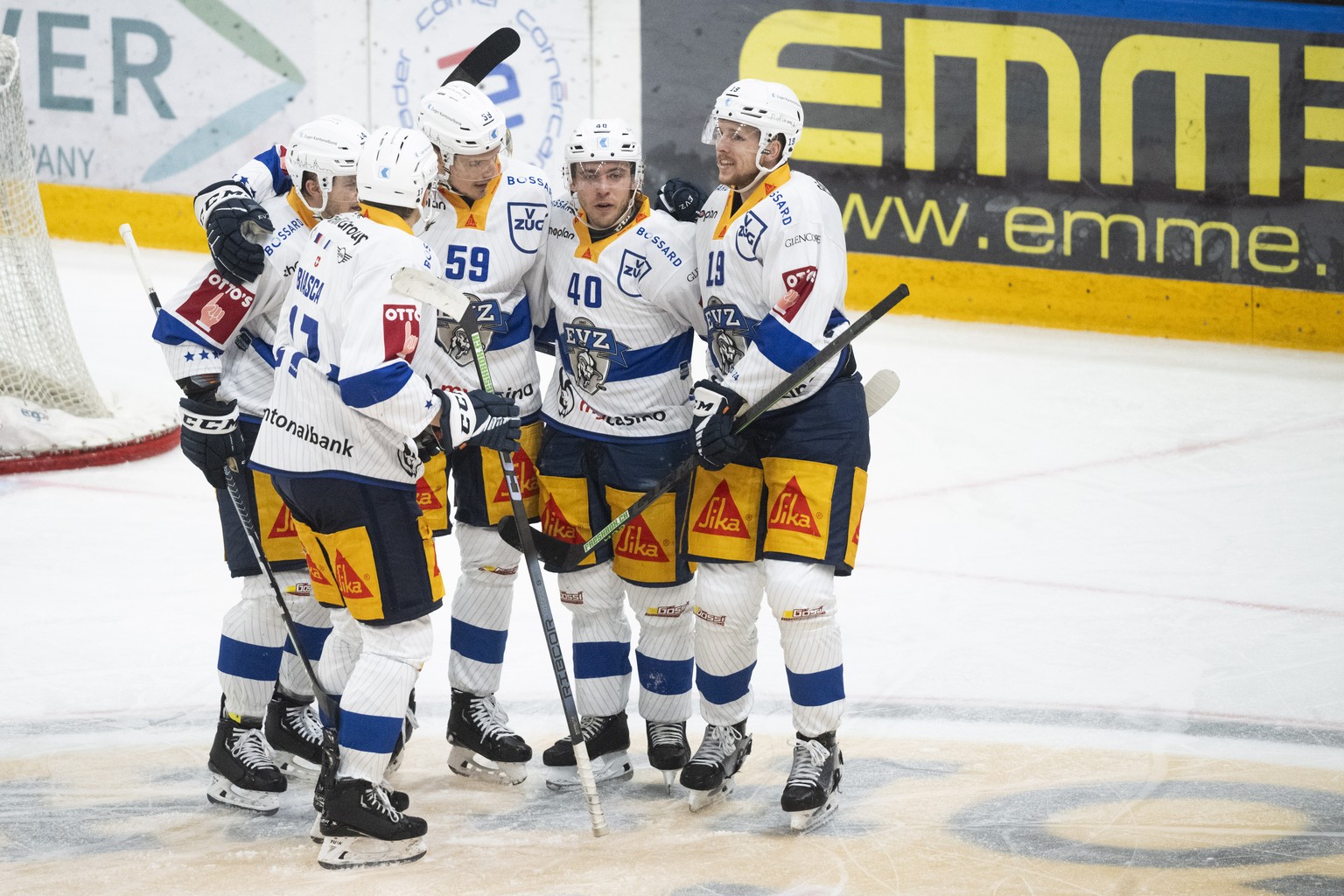 Right, Zug&#039;s player Niklas Hansson celebrate the 0-3 goal with teammate, during the preliminary round game of National League A (NLA) Swiss Championship 2023/24 between HC Lugano and EV Zug at th ...