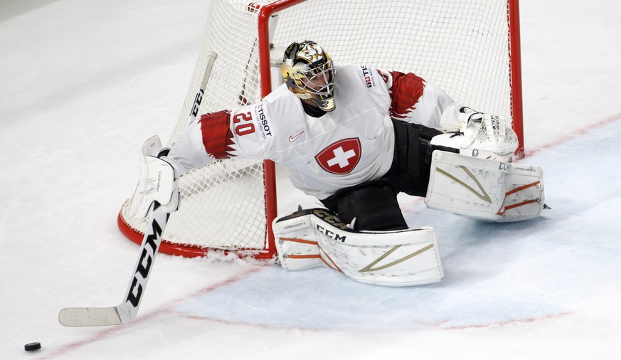 Switzerland&#039;s goaltender Reto Berra removes the puck, during the IIHF 2018 World Championship preliminary round game between Slovakia and Switzerland, at the Royal Arena, in Copenhagen, Denmark,  ...