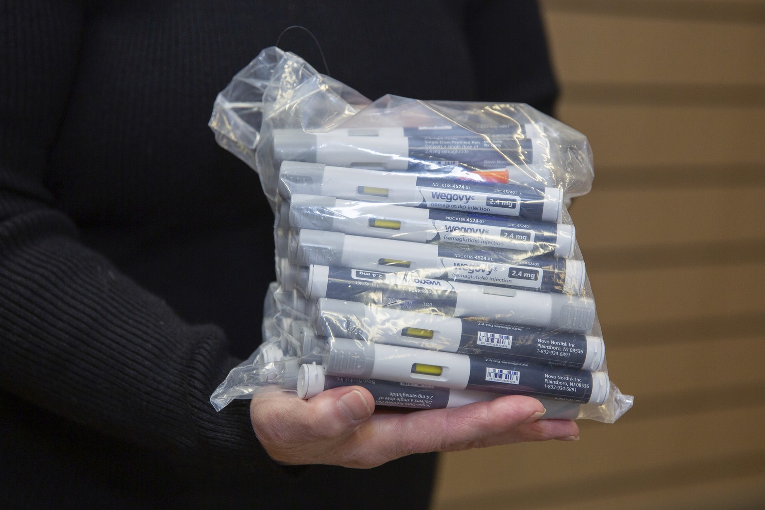 Patient Lory Osborn holds a bag of Wegovy pens used in her treatment at the Medical Weight Management office at West Virginia University in Morgantown, W.Va., Monday, Dec. 2, 2024. (AP Photo/Kathleen  ...