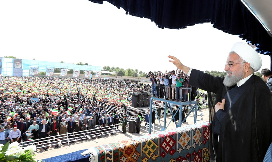 epa06714345 A handout photo made available by the Presidential office shows, Iranian President Hassan Rouhani greets the crowd in the city of Sabzevarr, northwestern Iran, 06 May 2018. Media reported  ...