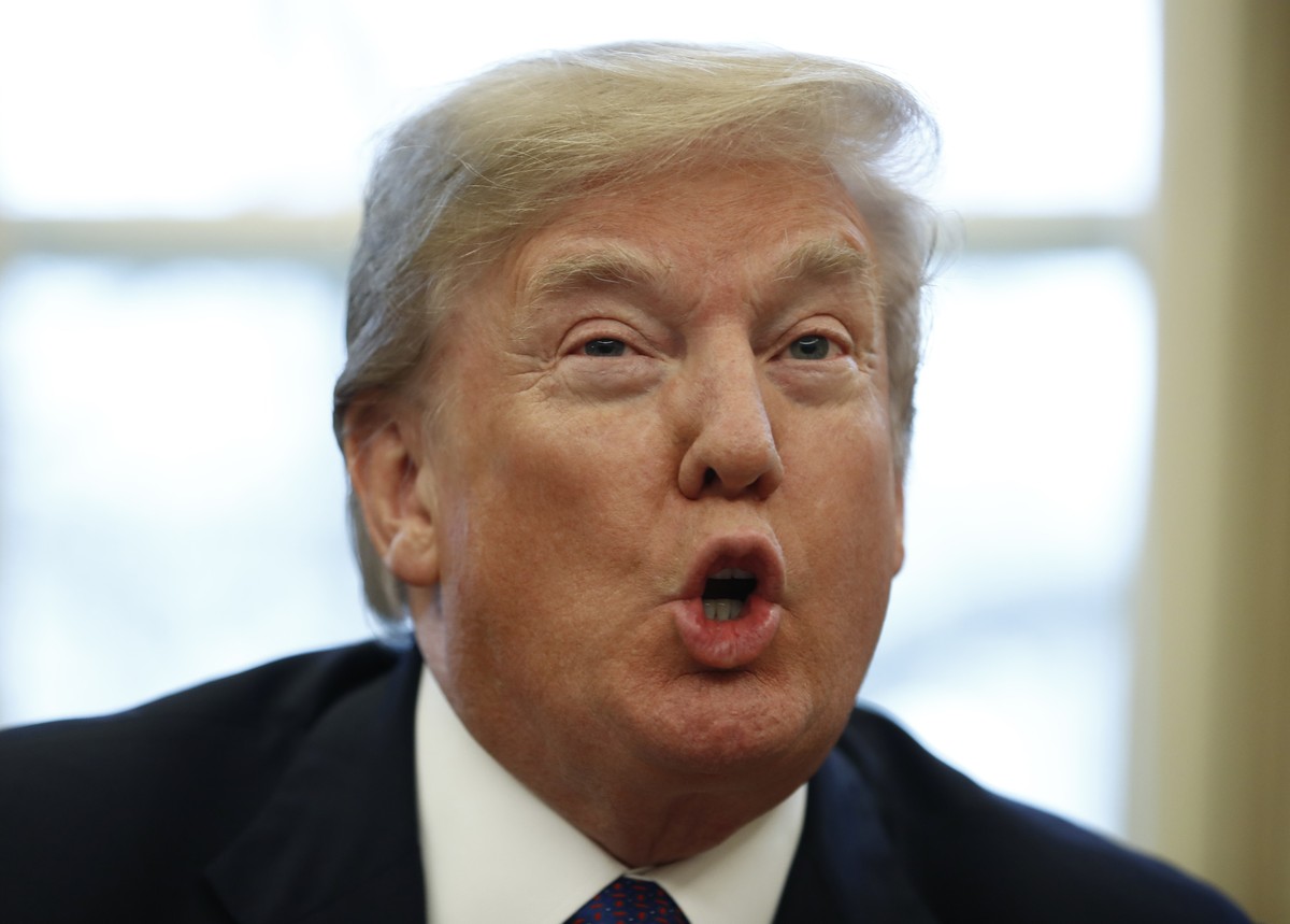 President Donald Trump speaks to media as he signs Section 201 actions in the Oval Office of the White House in Washington, Tuesday, Jan. 23, 2018. Trump says he is imposing new tariffs to "prote ...