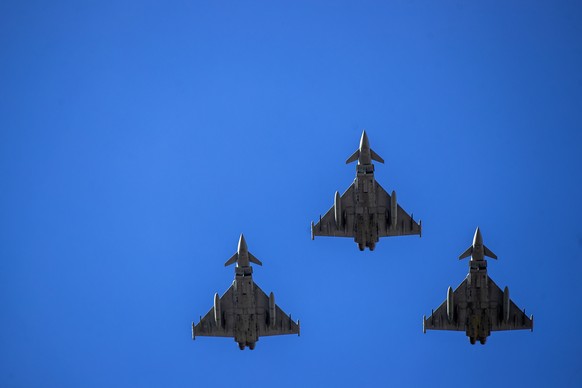 FILE - NATO fighter jets fly over Independence Square during a celebration of Lithuania&#039;s independence in Vilnius, Lithuania, Friday, March 11, 2022. As Russia���s military buildup near Ukraine a ...