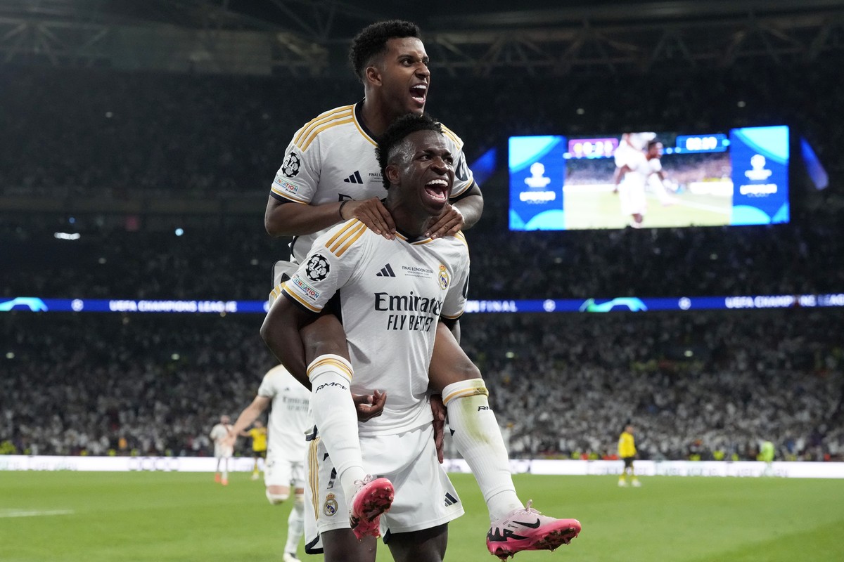 Real Madrid's Vinicius Junior celebrates with Rodrygo after scoring his side's second goal during the Champions League final soccer match between Borussia Dortmund and Real Madrid at Wembley ...