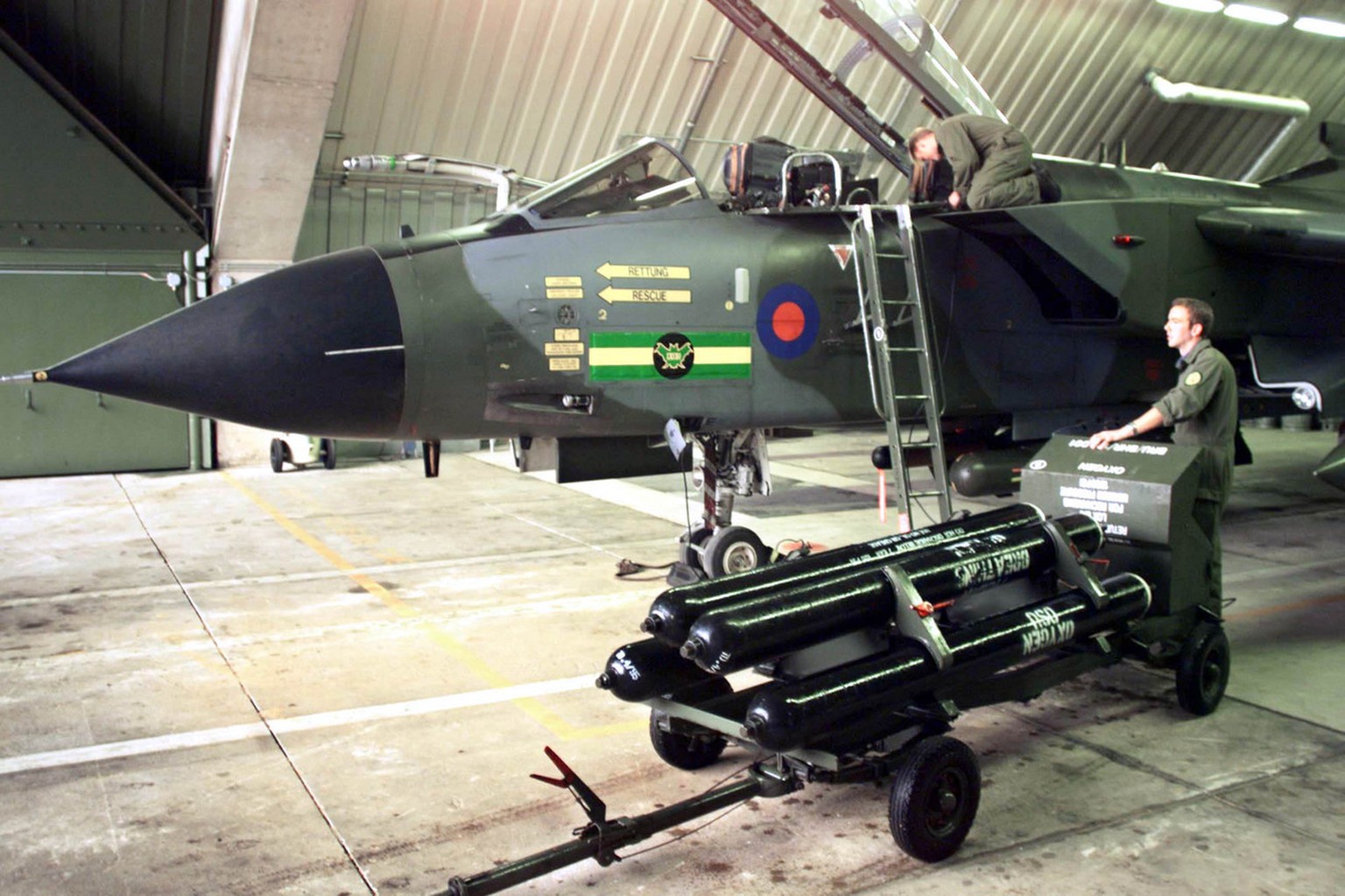 Britsih ground personel prepares the Tornado GR.1 fighting jet of the Royal airforce on Monday, April 5,1999 at the Brueggen/Elmpt airbase near Moenchengladbach in western Germany. The Tornado is a mo ...