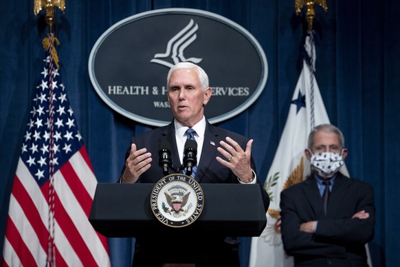 epa08510982 US Vice President Mike Pence participates in a White House Coronavirus Task Force news briefing as National Institute of Allergy and Infectious Diseases Director Anthony Fauci (R) looks on ...