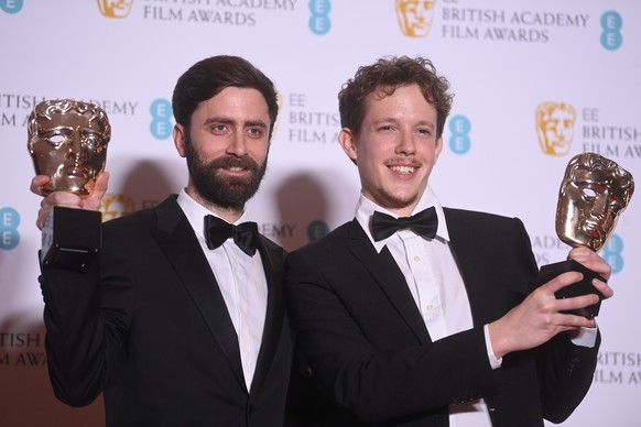 epa09822819 Jordi Morera (L) and Antonin Niclass (R), winners of the British Short Animation award for the film Do Not Feed the Pigeons, pose in the press room during the 75th BAFTA Film Awards at the ...