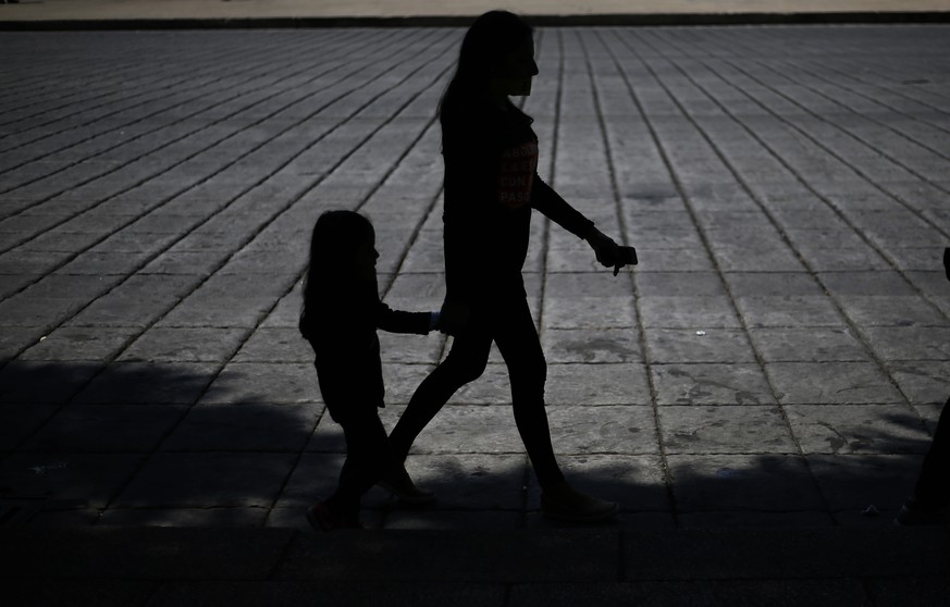 In this Saturday, Oct. 14, 2017 photo, a woman and girl walk during a march against human trafficking and slavery in Mexico City. Dozens of people participated in Mexico City&#039;s silent &quot;Walk  ...