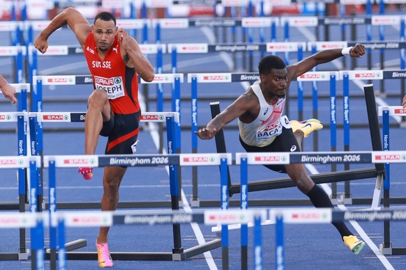 Belgium's Elie Bacari, right, falls in his men's 110 meters hurdles semifinal as Switzerland's Jason Joseph competes at the European Athletics Championships in Birmingham, England, Wedn ...