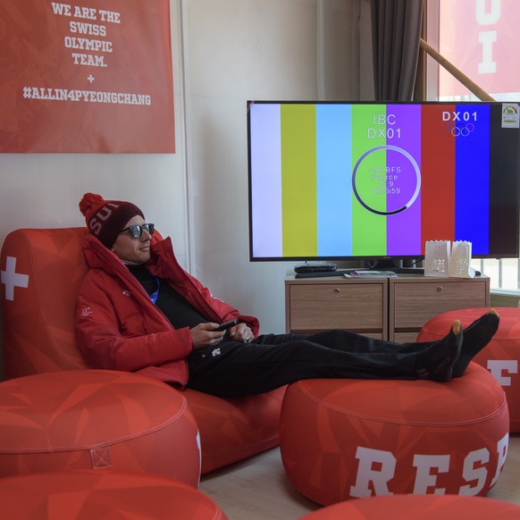 Swiss ski jumping athlete Simon Ammann watches tv during a media tour through the Pyeongchang Olympic Village one day prior to the opening of the XXIII Winter Olympics 2018 in Pyeongchang, South Korea ...