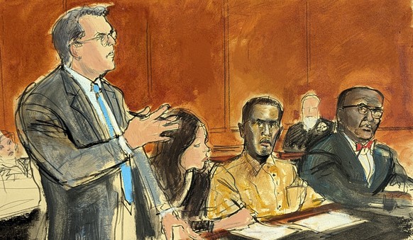 In this courtroom sketch, Sean &quot;Diddy&quot; Combs defense attorney Marc Agnifilo, left, addresses the judge while Combs, seated second from right, in prison uniform, watches in Federal court, in  ...