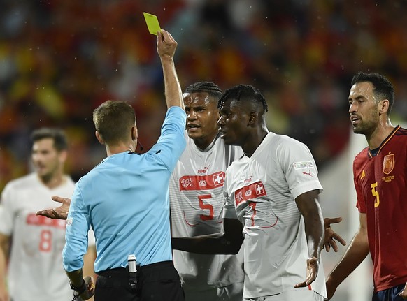 Referee Clement Turpin shows a yellow card to Switzerland&#039;s Manuel Akanji during the UEFA Nations League soccer match between Spain and Switzerland, at the Benito Villamarin Stadium, in Seville,  ...