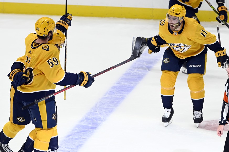 Nashville Predators center Matt Duchene, left, celebrates with defenseman Roman Josi (59) and center Luke Kunin (11) after Duchene scored the winning goal against the Colorado Avalanche during overtim ...