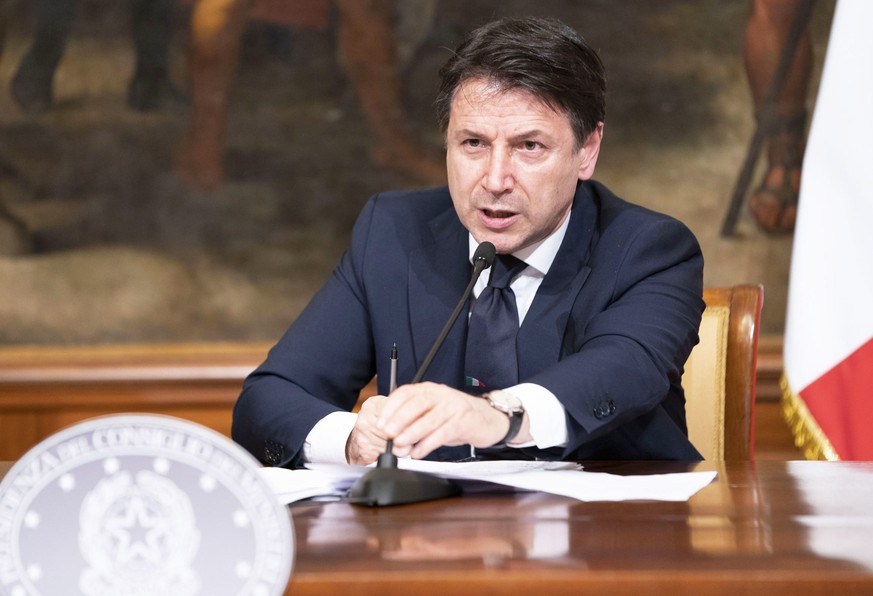 epa08346775 A handout photo made available by the Chigi Palace Press Office shows Italian Prime Minister Giuseppe Conte attending a press conference at the end of a Cabinet meeting on the coronavirus  ...