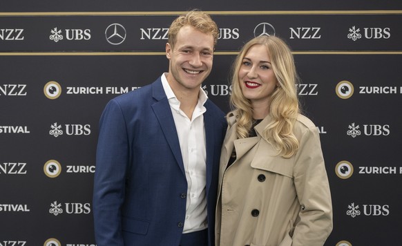 epa11642078 Swiss ski racer Marco Odermatt (L) and Stella Parpan pose on the Green Carpet before the screening of the documentary film &#039;Aiming High - A Race Against the Limits&#039; at the 20th Z ...