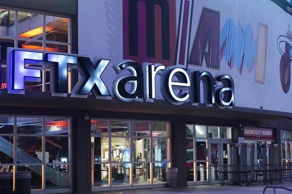 FILE - Signage for the FTX Arena, where the Miami Heat basketball team plays, is illuminated on Saturday, Nov. 12, 2022, in Miami. The rapid collapse of cryptocurrency exchange FTX into bankruptcy las ...