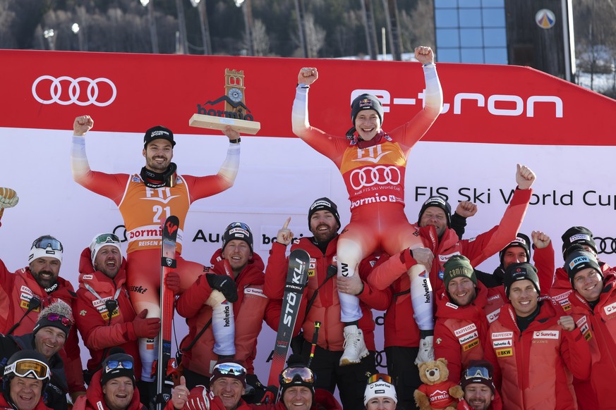 Switzerland&#039;s Marco Odermatt, right, winner of an alpine ski, men&#039;s World Cup Super G race, and third-placed Switzerland&#039;s Loic Meillard celebrate with the team, in Bormio, Italy, Thurs ...