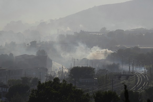 Smoke is seen by rail tracks during a wildfire Tuesday, July 8, 2025 in Marseille, southern France. (AP Photo/Lewis Joly)
France Marseille Fire