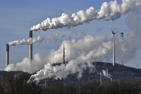 FILE --- A Uniper energy company coal-fired power plant and a BP refinery are seen beside a wind generator in Gelsenkirchen, Germany, Jan. 16, 2020. A senior German official predicted Tuesday that the ...