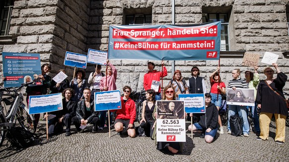 epa10713286 Participants, among them petitioner Britta Haefemeier (C), pose with a banner reading &#039;Mrs. Spranger, act!&#039; and the hashtag &#039;no stage for Rammstein&#039; during a &#039;No s ...