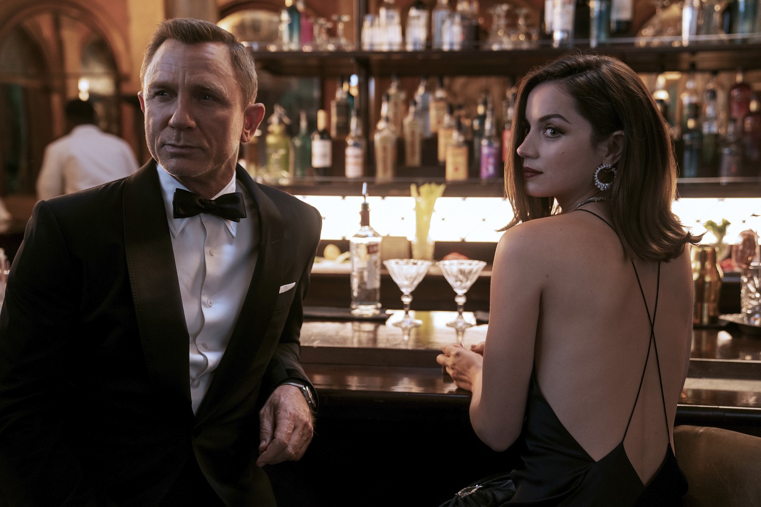 This image released by Metro Goldwyn Mayer Pictures shows Daniel Craig, left, Ana de Armas in a scene from &quot;No Time To Die.&quot; (Nicola Dove/Metro Goldwyn Mayer Pictures via AP)