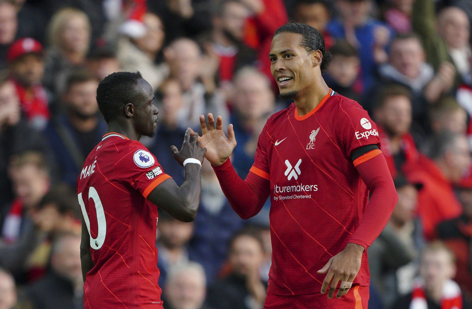 Liverpool&#039;s Sadio Mane, left, celebrates with Virgil van Dijk after scoring their side&#039;s first goal, during the English Premier League soccer match between Liverpool and Manchester City at A ...