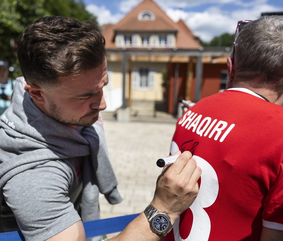 epa11402253 Switzerland&#039;s Xherdan Shaqiri signs autographs upon arrival at the team hotel &#039;Waldhotel&#039; in Stuttgart, Germany, 10 June 2024. The Swiss national soccer team will be based a ...