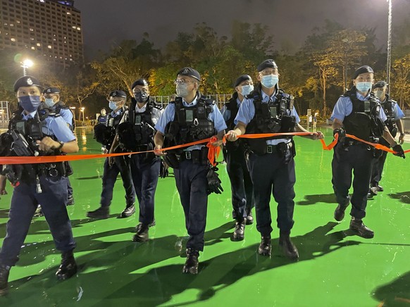 Police officers set up a cordon as Hong Kong authorities announced a temporary closure of the Victoria Park where the candlelight vigil used to be held, ahead of the 33rd anniversary to commemorate th ...