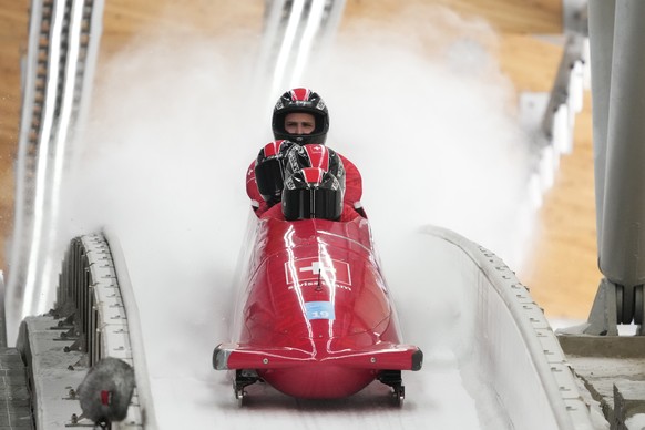 Michael Vogt of Switzerland and his team finish during a 4-man bobsleigh training heat at the 2022 Winter Olympics, Thursday, Feb. 17, 2022, in the Yanqing district of Beijing. (AP Photo/Dmitri Lovets ...