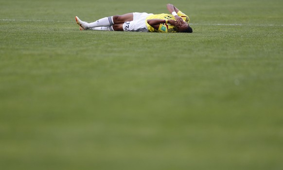 Colombia&#039;s Johan Mojica holds his face after a challenge by Japan&#039;s Genki Haraguchi during the group H match between Colombia and Japan at the 2018 soccer World Cup in the Mordavia Arena in  ...