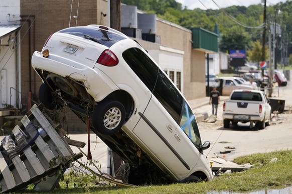 A car leans against a utility pole Sunday, Aug. 22, 2021, in Waverly, Tenn. Heavy rains caused flooding in Middle Tennessee and have resulted in multiple deaths as homes and rural roads were washed aw ...