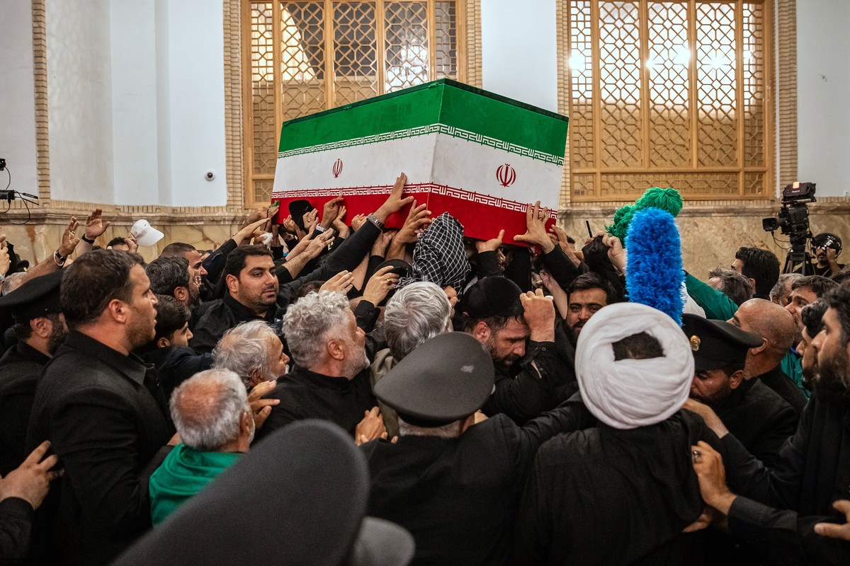 In this photo released by Iran's Supreme Leader's office, mourners carry the coffin of the late Iranian Supreme Leader Ayatollah Ali Khamenei above the crowd for the final prayer before his  ...