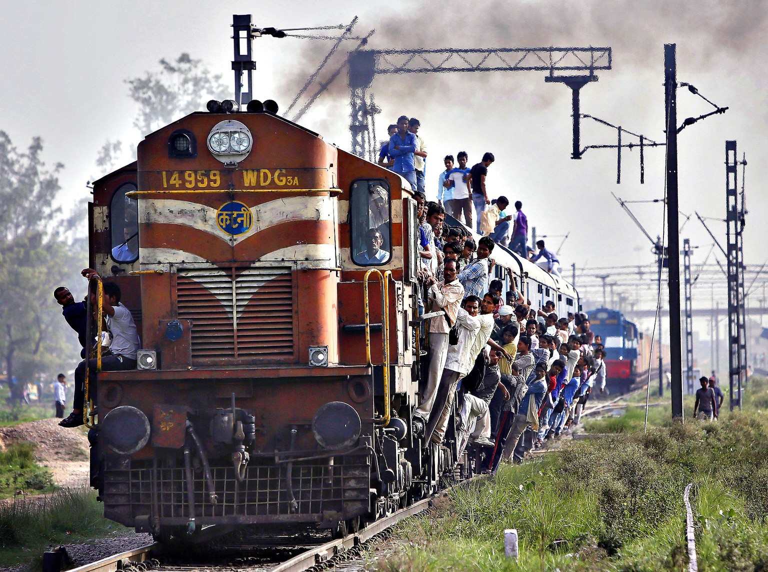 Passengers travel on an overcrowded train at Loni town in Uttar Pradesh...Passengers travel on an overcrowded train at Loni town in the northern Indian state of Uttar Pradesh July 8, 2014. On Tuesday, ...